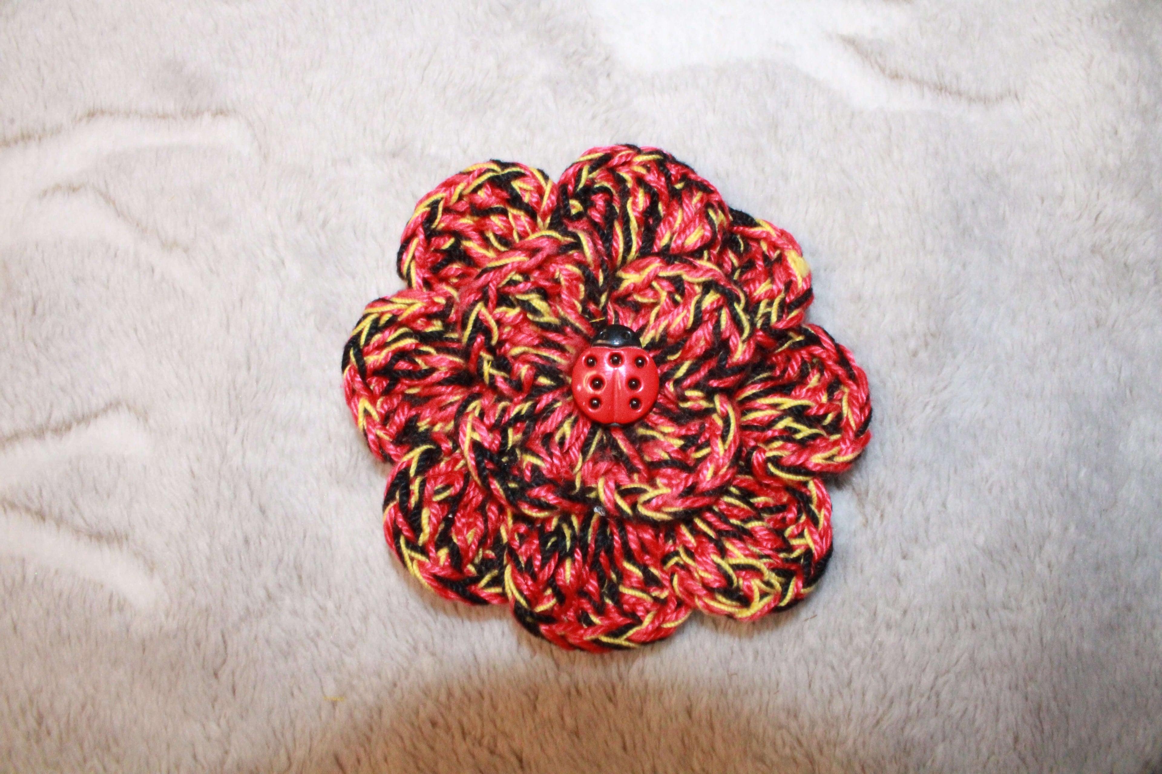 Ladybug Fashion Flower crafted with handmade techniques for a truly unique style.