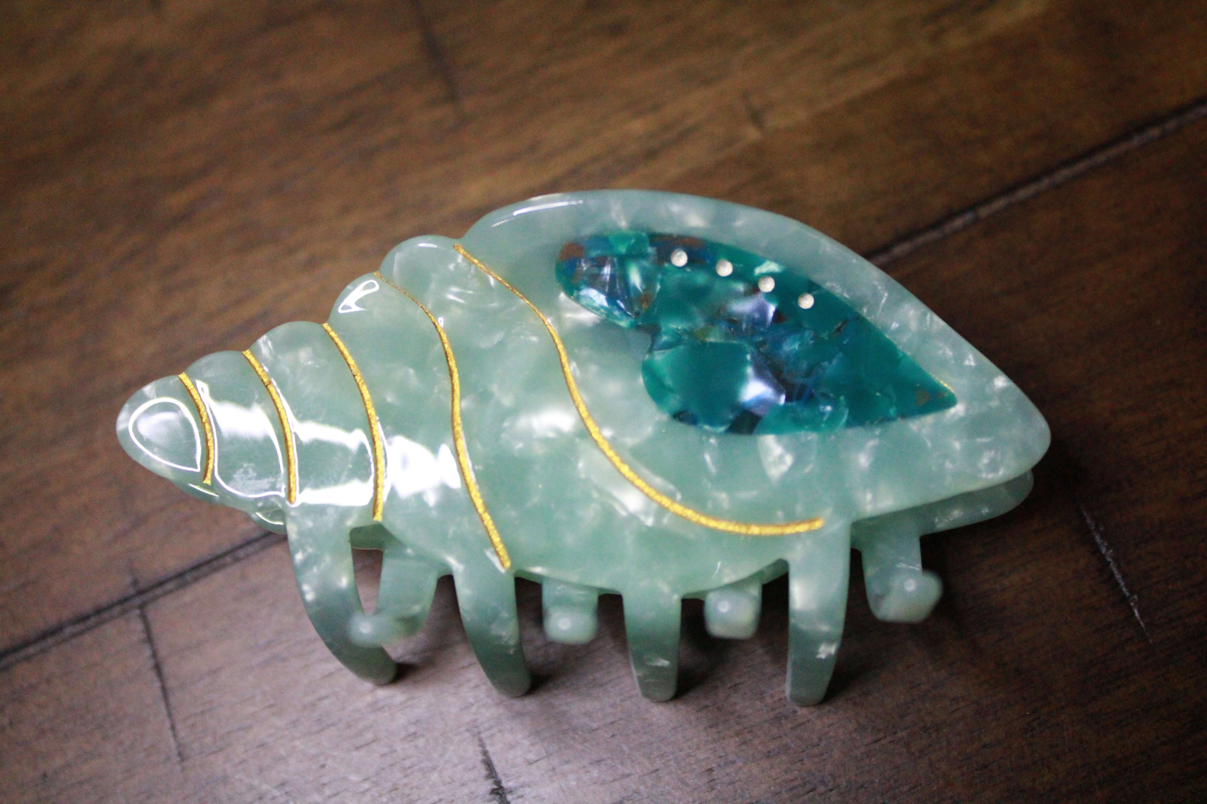 Stylish Cute Blue Caribbean Conch Shape Hair Claw Clips Strong Hold featuring unique designs, perfect for adding a touch of flair to any hairstyle.